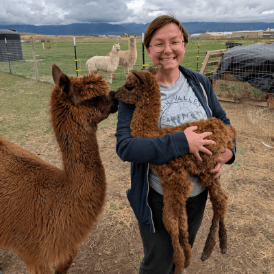Trainer Jessica holding baby alpaca Storm