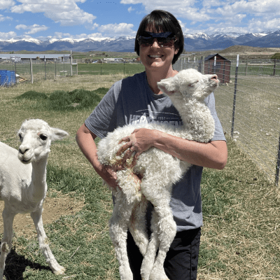 Trainer Robyn holding baby alpaca Tornado